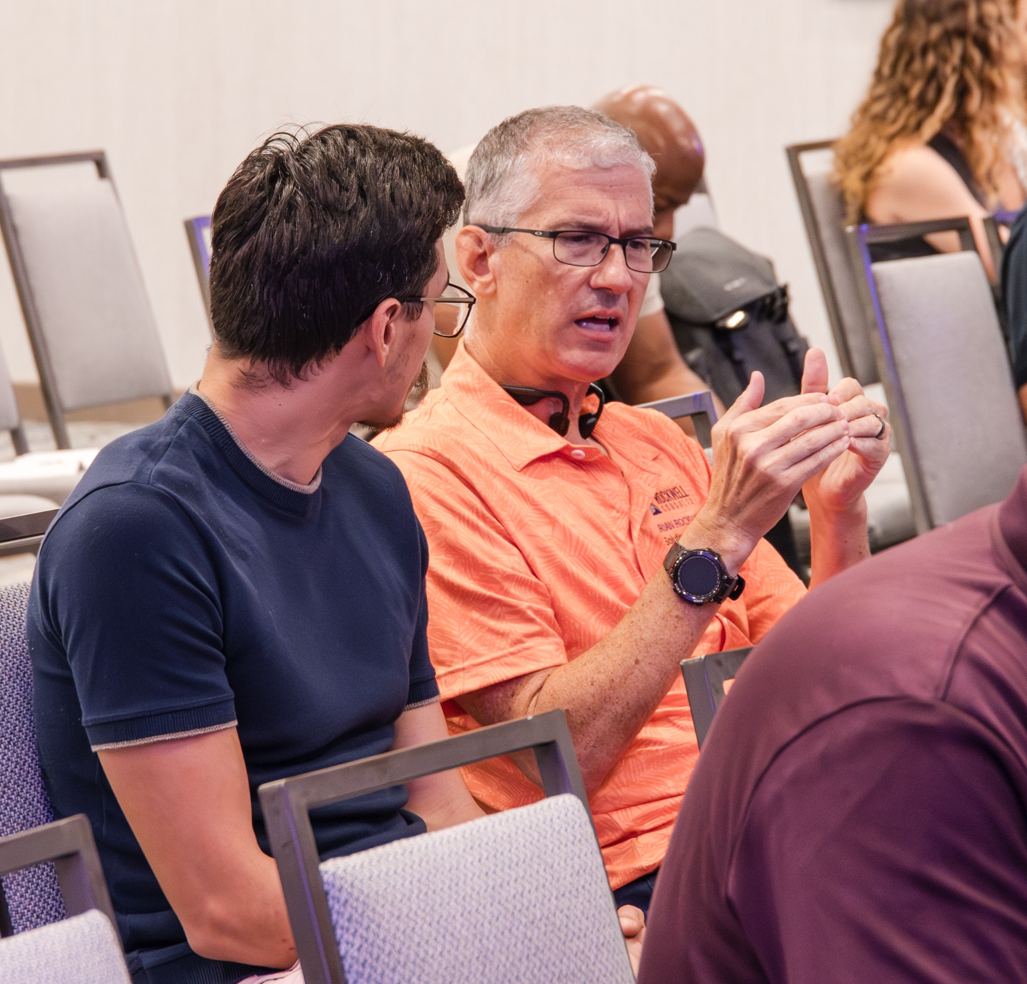 Attendees in conversation during the presentation