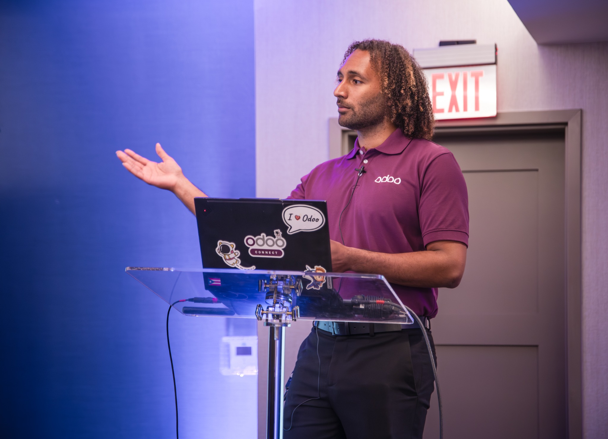 Odoo speaker addressing attendees from a lectern