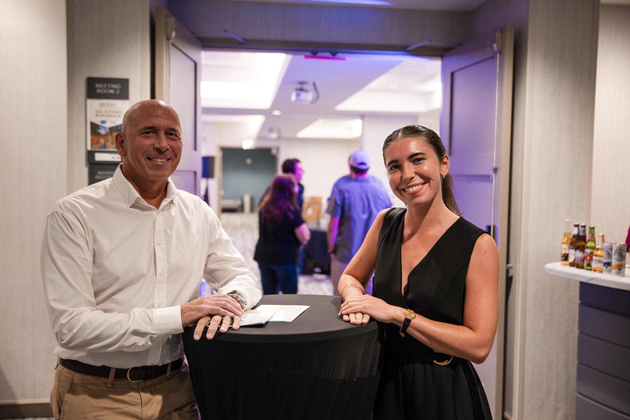 Guests smiling beside a reception table