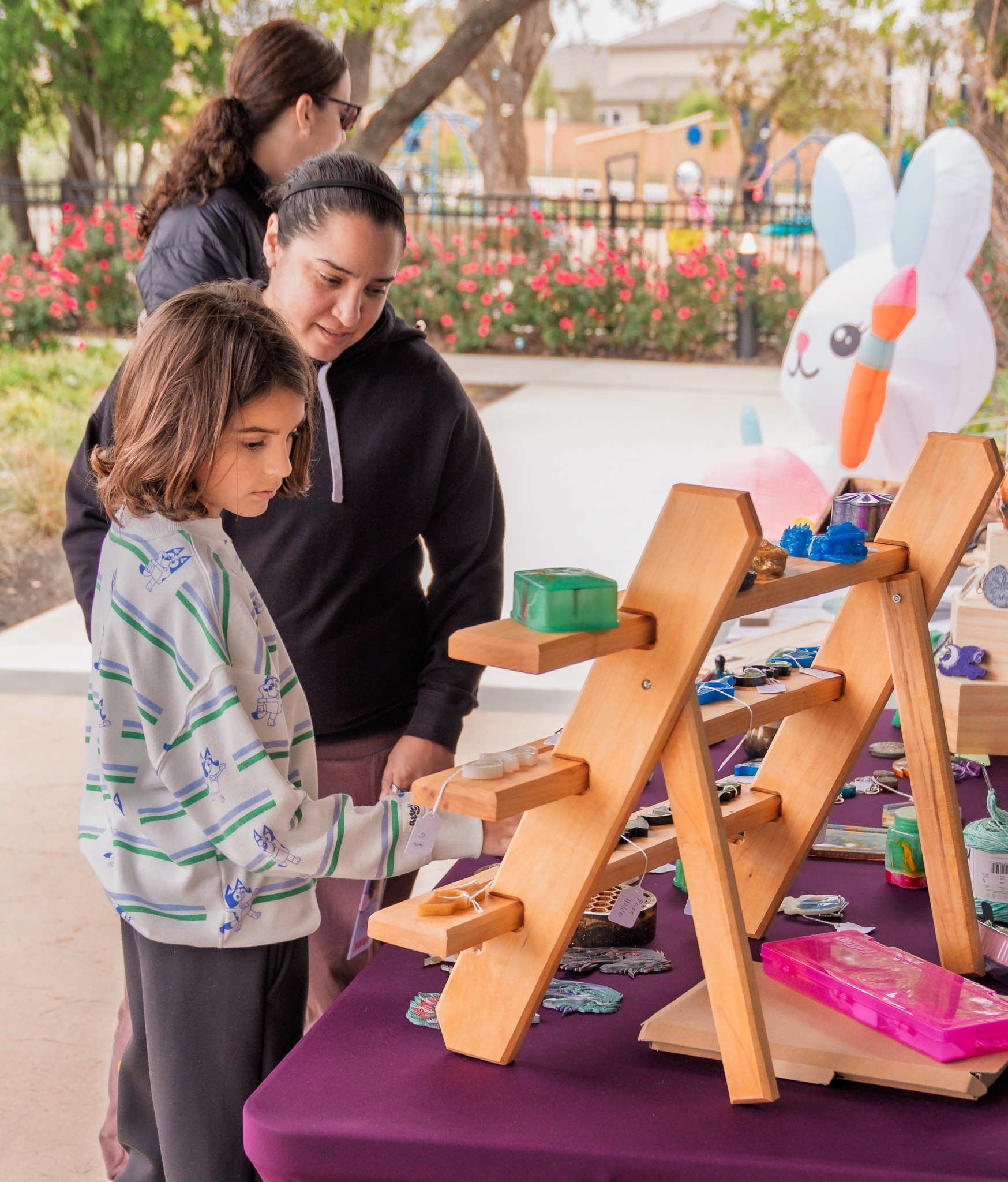 Vendor helping a young guest with an activity