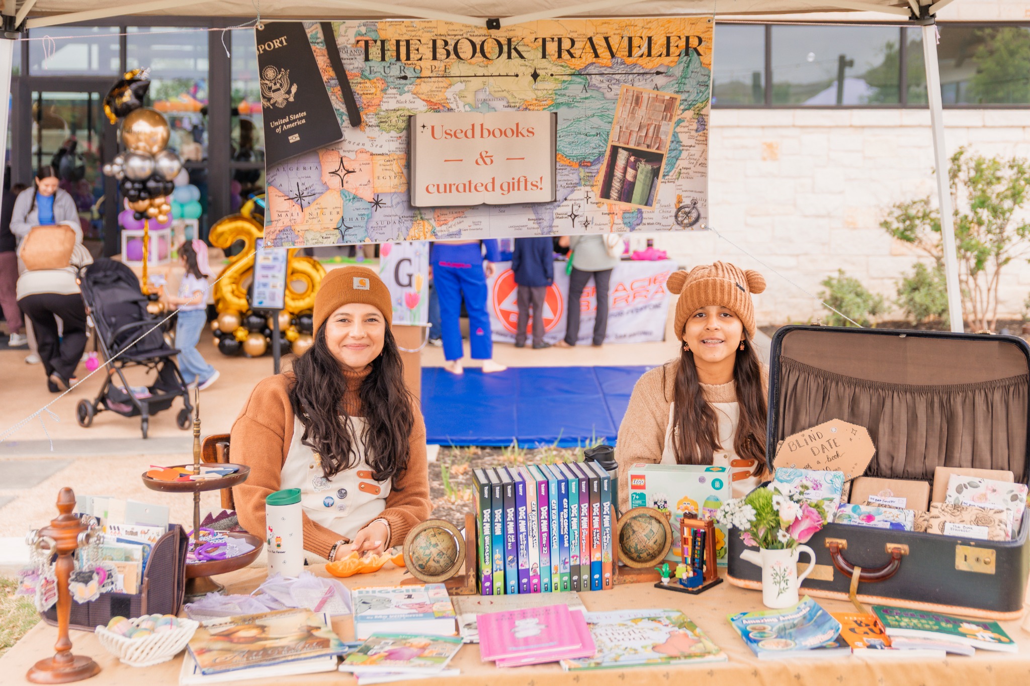 The Book Traveler representatives at their colorful vendor booth
