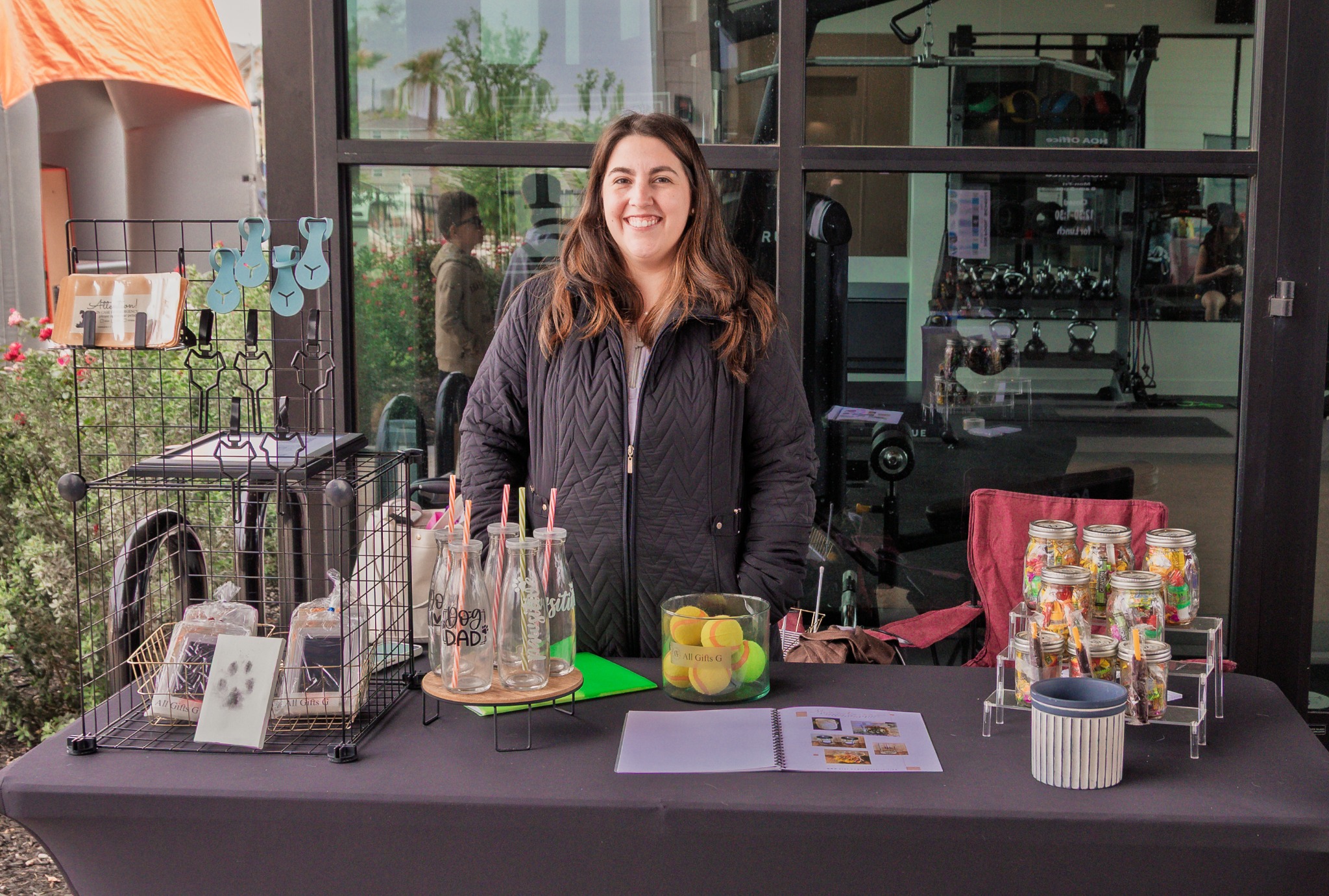 Vendor posing behind a carefully arranged product display