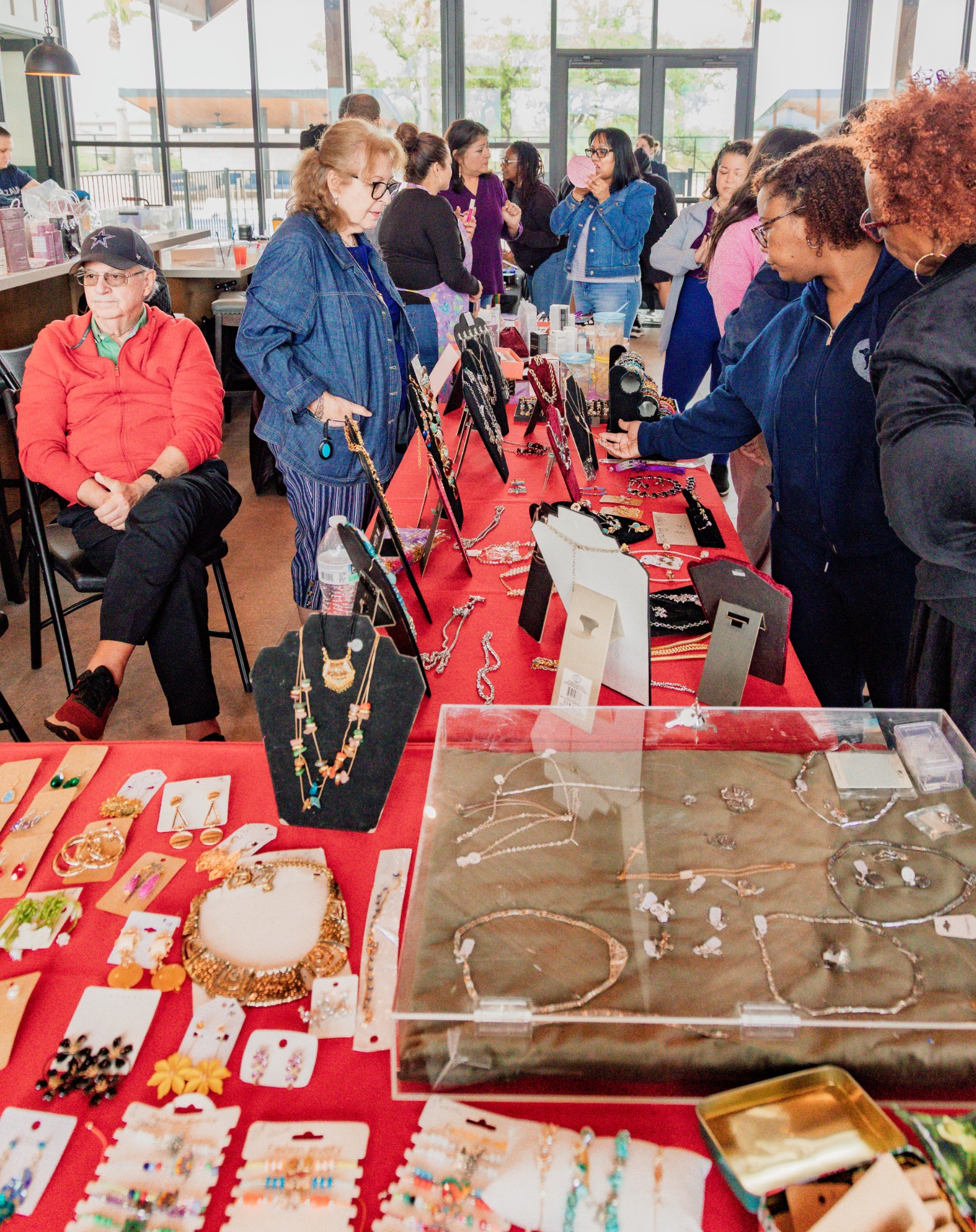 Guests engaging with merchandise at a vendor table