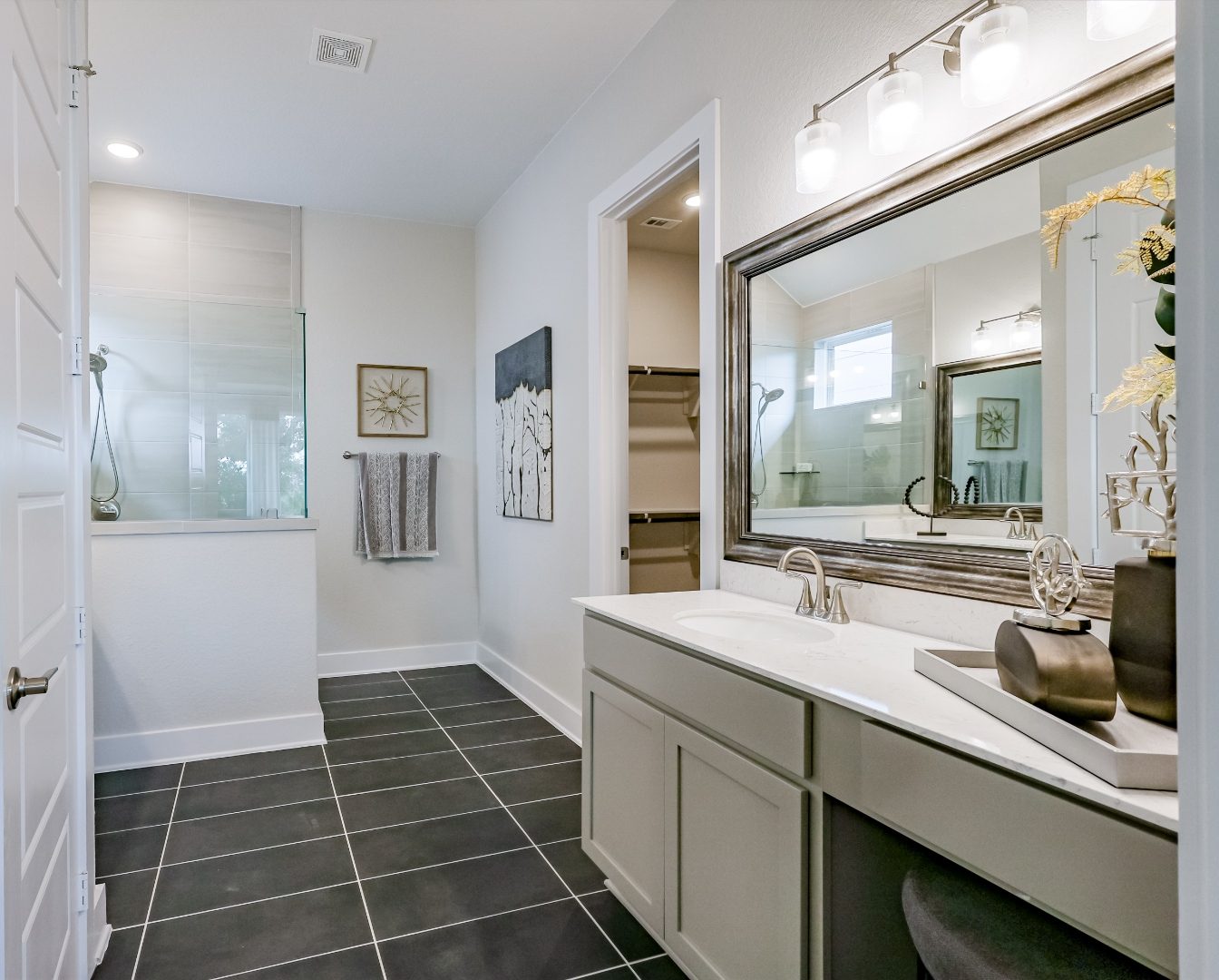 Primary bathroom with walk-in shower and framed mirror