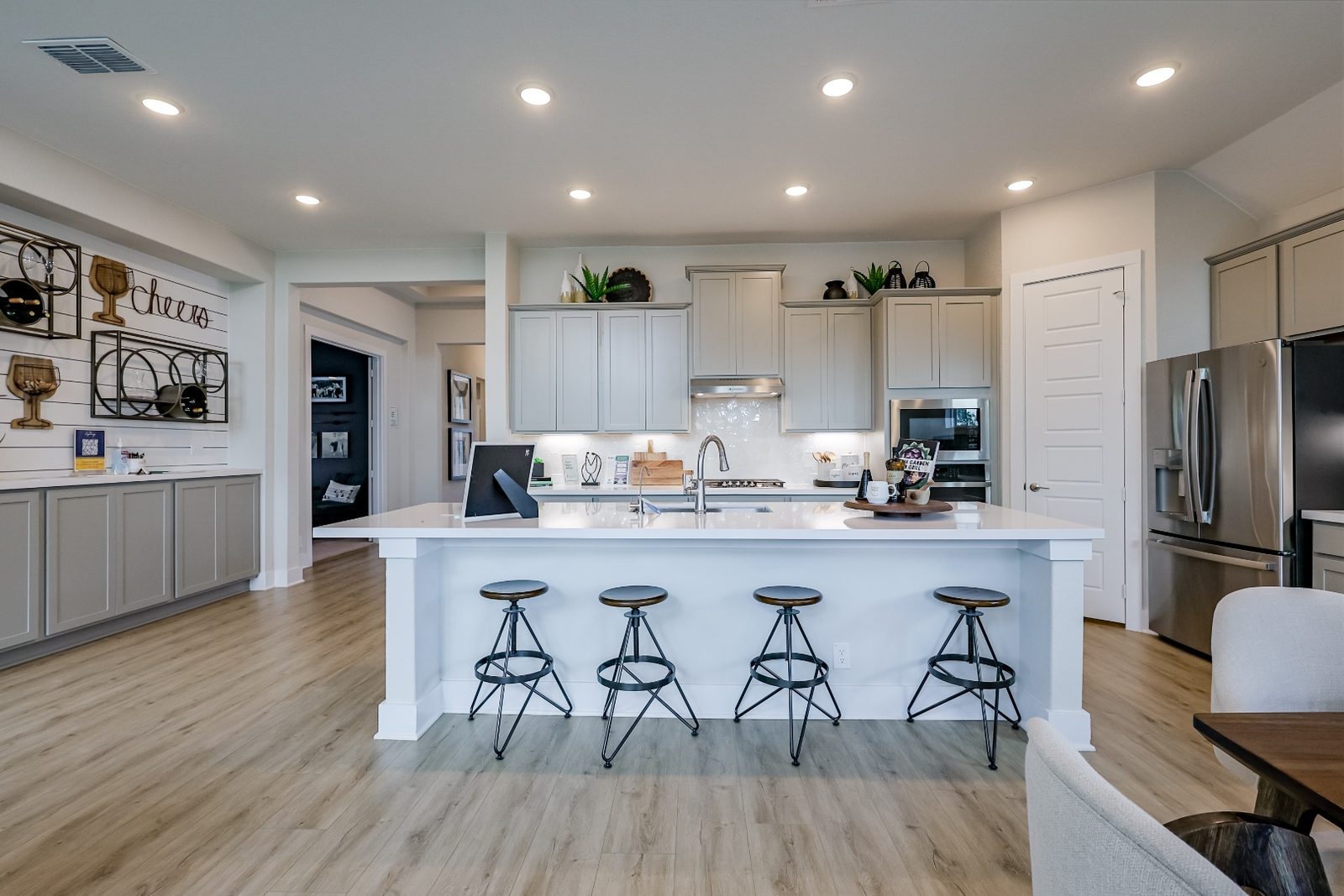 Kitchen island with bar stools and stainless appliances