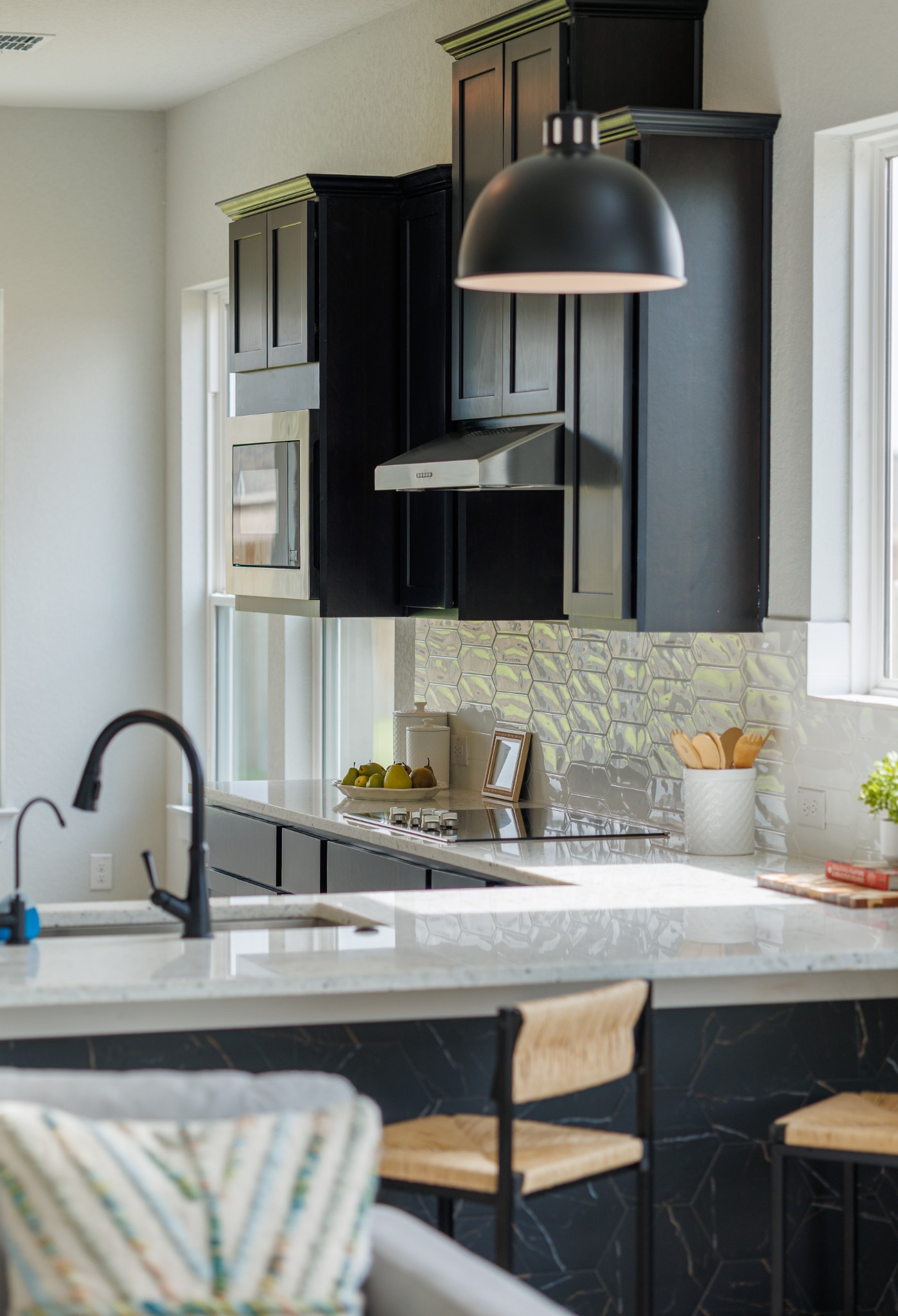 Dark kitchen cabinetry and pendant lighting